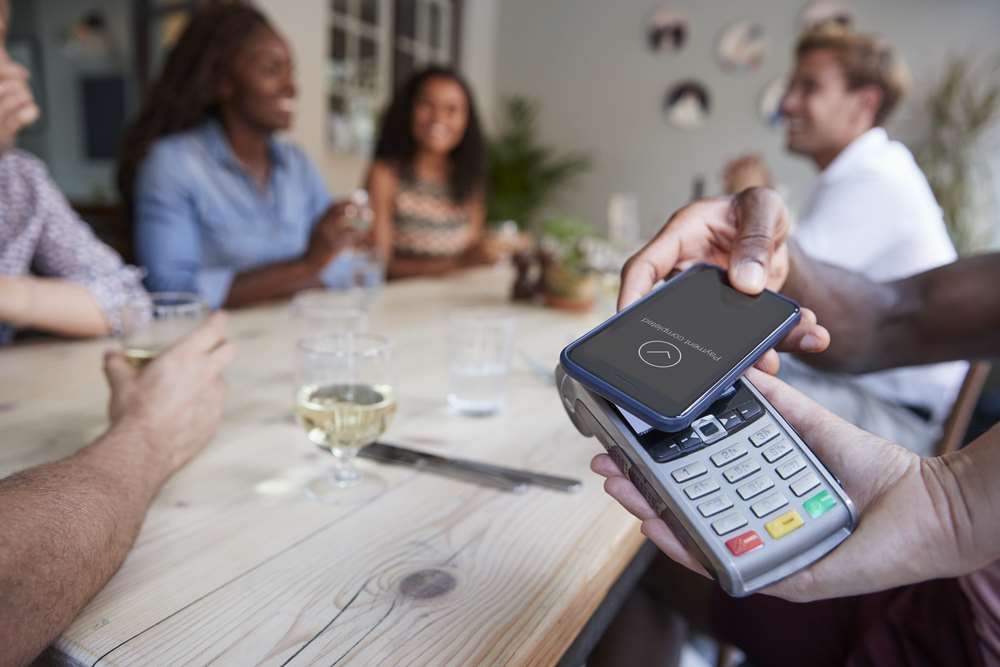 Credit and debit cards on a table, symbolizing the cashless payment debate - Global Banking & Finance Review