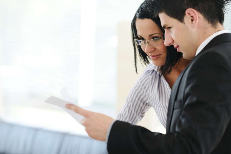 Personal financial advisor assisting client with tablet in banking context - Global Banking & Finance Review