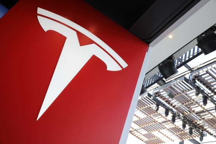 Tesla logo displayed prominently, reflecting the company's financial performance - Global Banking & Finance Review