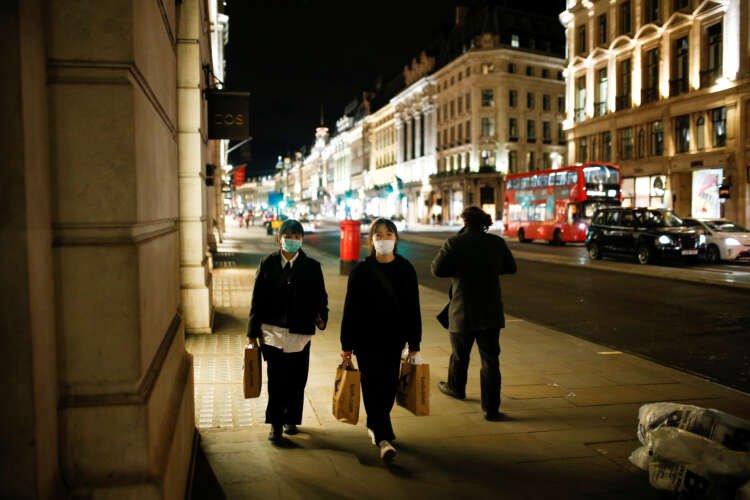 People in face masks walking on Regent Street, reflecting COVID-19 concerns in London - Global Banking & Finance Review