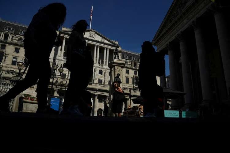 Pedestrians walking by the Bank of England, reflecting the impact of interest rate hikes - Global Banking & Finance Review
