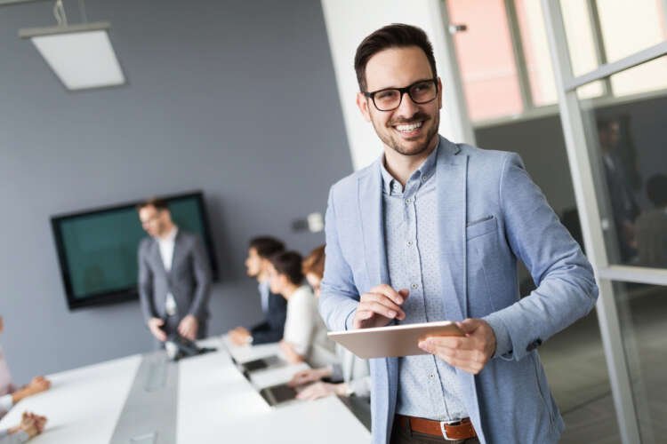 Successful businessman with tablet exemplifying entrepreneurial spirit - Global Banking & Finance Review