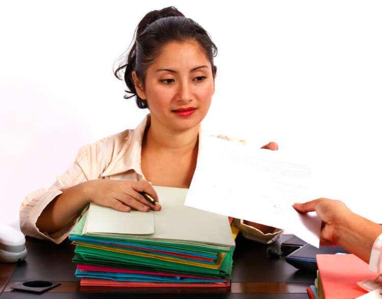 Manager receiving a document, symbolizing secure document management for remote work - Global Banking & Finance Review