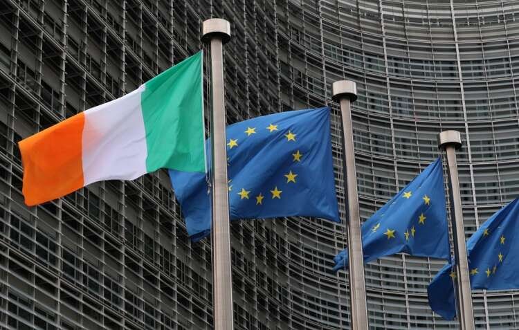 Irish and European flags fly outside the European Commission headquarters in Brussels