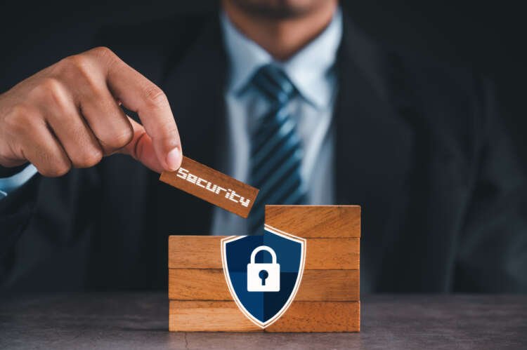 Businessman demonstrating digital security concepts for financial services - Global Banking & Finance Review