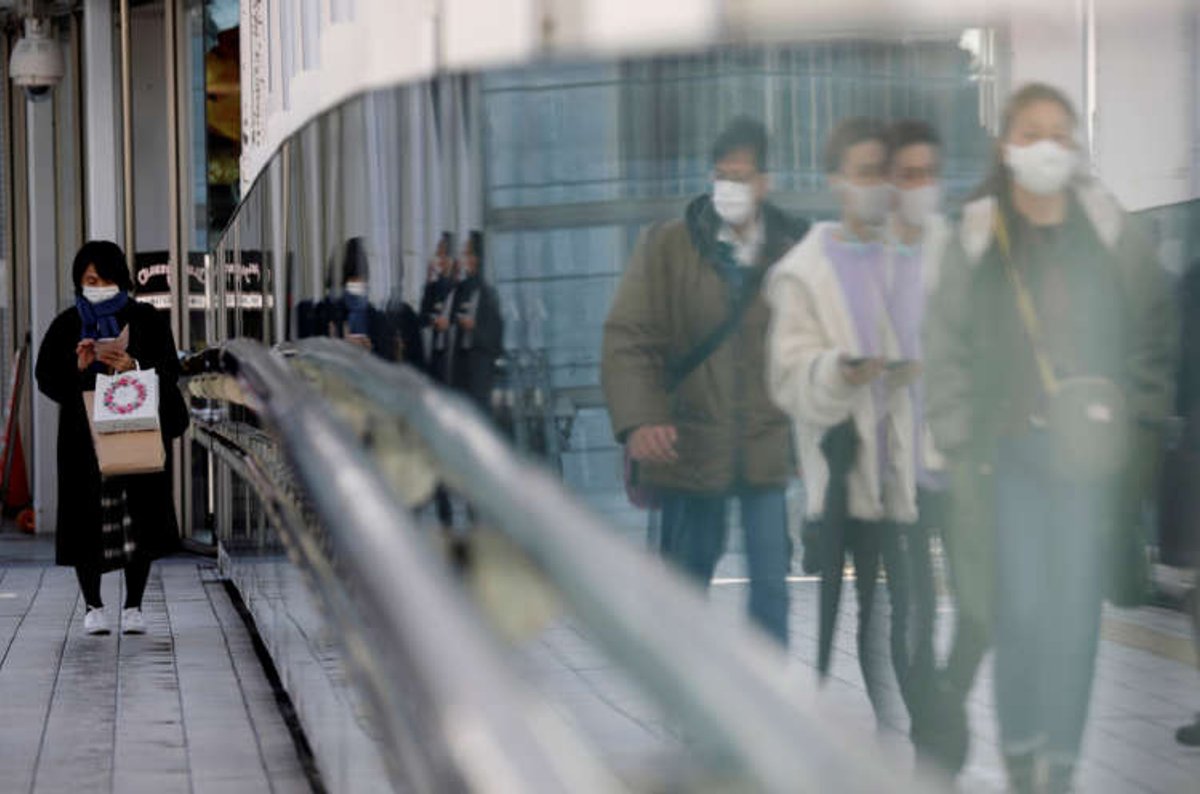 FILE PHOTO: Pedestrians walk on a street in Tokyo, Japan amid the COVID-19 outbreak