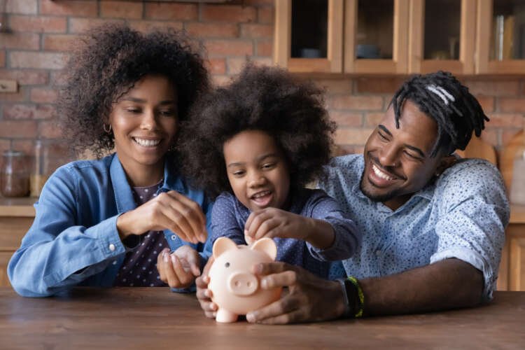 Caring African American parents teaching their daughter about saving money - Global Banking & Finance Review