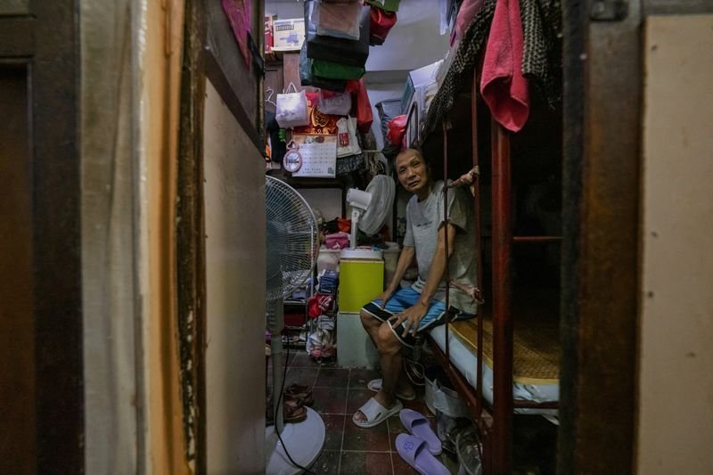 Interior of a cramped Hong Kong home showcasing living conditions - Global Banking & Finance Review