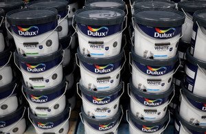 AkzoNobel logo with a backdrop of a factory, highlighting layoffs in France - Global Banking & Finance Review