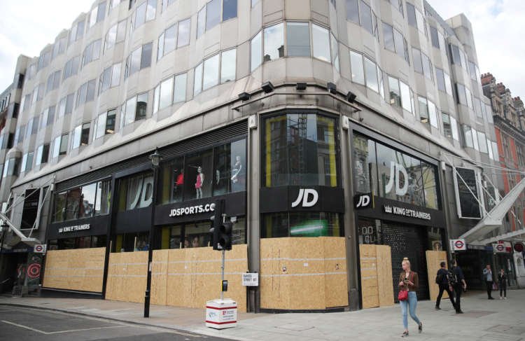 Shops are seen boarded up in Oxford Street, in London