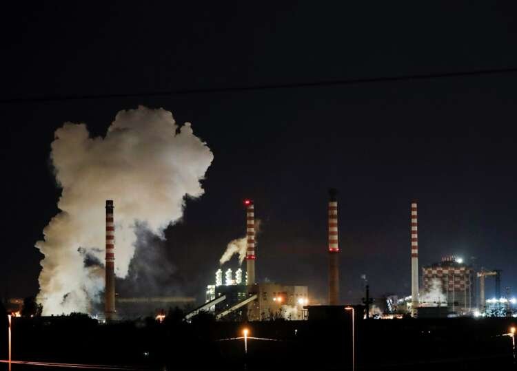 Steam rises from Ilva steel plant chimneys, highlighting Italy's manufacturing contraction - Global Banking & Finance Review