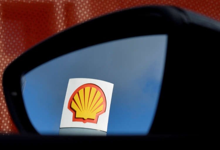Shell logo reflected in a car mirror, symbolizing impact of Dutch court ruling - Global Banking & Finance Review