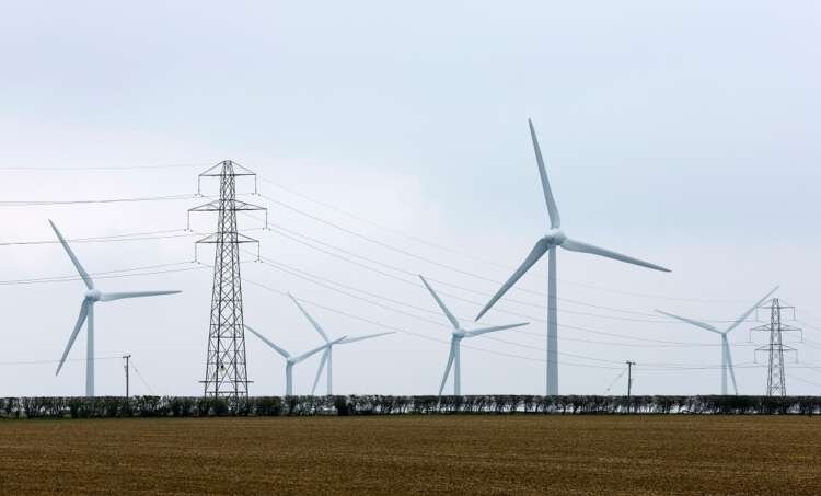 Wind turbines and power pylons symbolize UK's energy trends - Global Banking & Finance Review