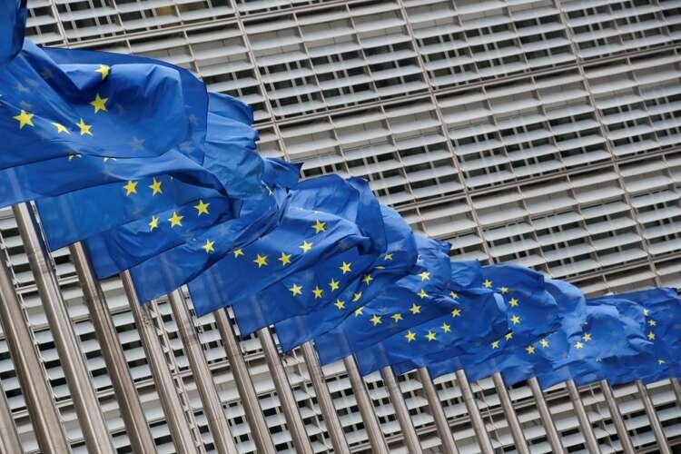 EU flags waving outside the European Commission, highlighting climate policy discussions - Global Banking & Finance Review