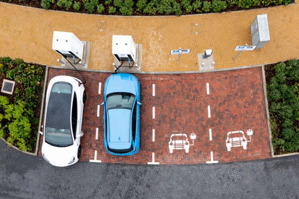 Aerial view of an electric vehicle charging at a station, reflecting EV charging trends - Global Banking & Finance Review