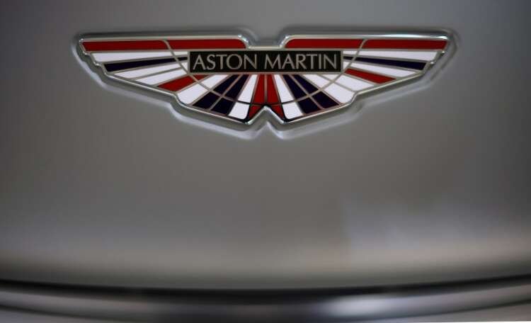 Aston Martin logo on a V12 Vantage car, representing the brand's luxury status - Global Banking & Finance Review