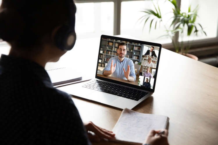 Woman participating in a group video call, reflecting hybrid work culture - Global Banking & Finance Review