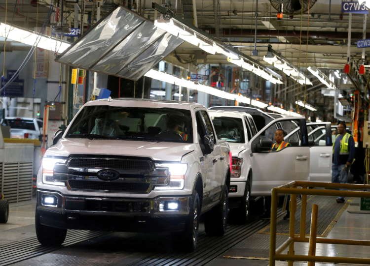 Ford F150 trucks on assembly line showcasing EV battery development - Global Banking & Finance Review