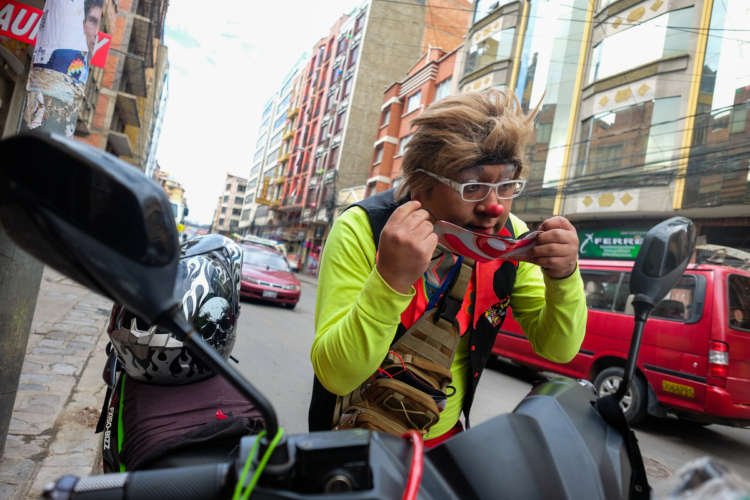 Reynaldo Luna delivering handmade face masks by motorbike amid COVID-19 crisis in Bolivia - Global Banking & Finance Review