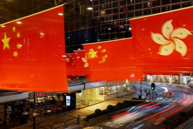 Chinese and Hong Kong flags adorn a street in Hong Kong, symbolizing the city's 1997 return to China - Global Banking & Finance Review