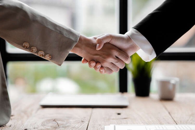 Svenja Damzog, new Publisher Director DACH at Adnami, shaking hands - Global Banking & Finance Review