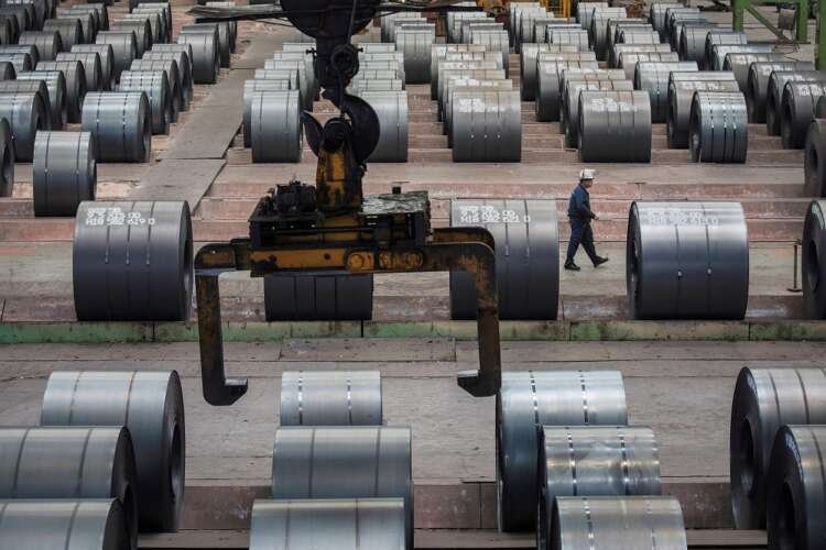 Worker inspects steel rolls at Chongqing Iron and Steel plant amid China's factory inflation decline - Global Banking & Finance Review