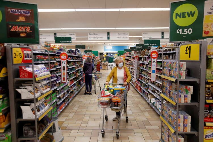 Customer wearing a mask shops at Morrisons amidst potential investor vote - Global Banking & Finance Review