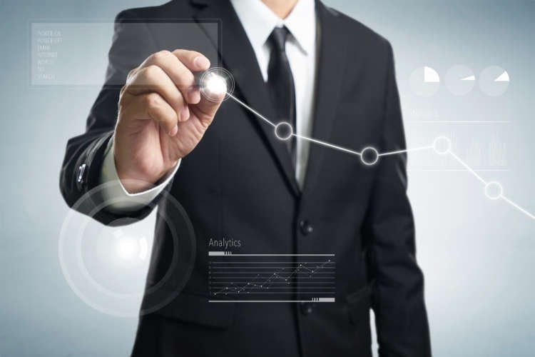 Businessman analyzing financial graphs representing digital transformation in capital markets - Global Banking & Finance Review