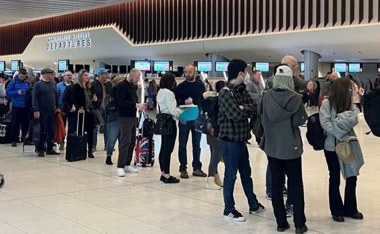 Passengers queue for security screening in the departures area of Terminal 2 at Manchester Airport, in Manchester