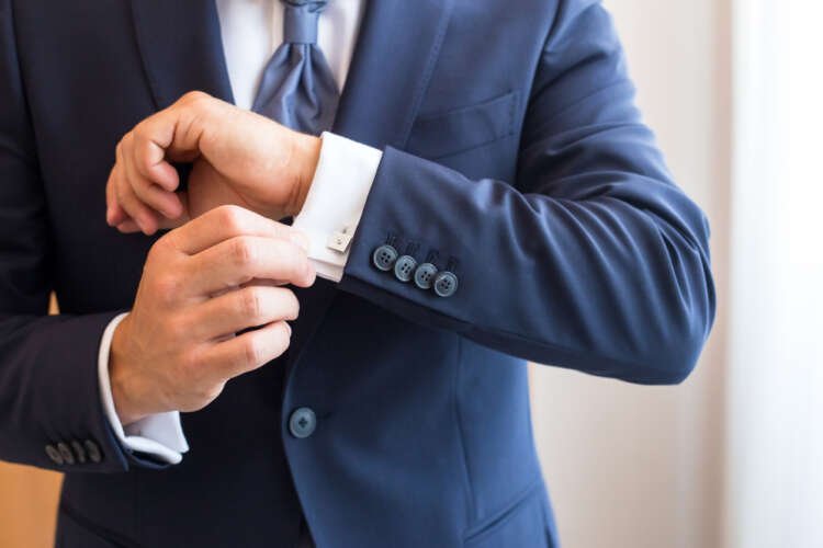 Professional banker in white shirt and cufflink, symbolizing wealth management services - Global Banking & Finance Review