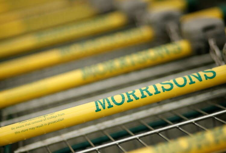 Shopping trolleys outside a Morrisons supermarket related to business news - Global Banking & Finance Review