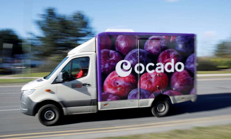 Ocado delivery van on the road, highlighting ultra-fast grocery delivery trends - Global Banking & Finance Review