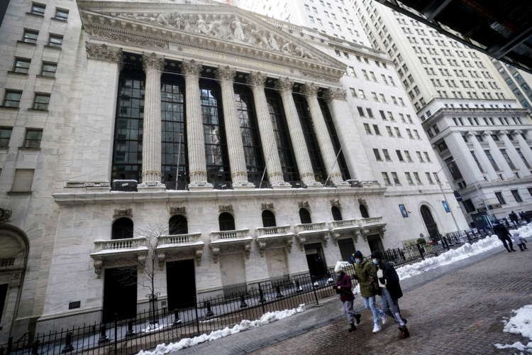 People walk past the New York Stock Exchange in New York City
