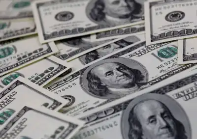 Image for Dollar slides to two-week low as tame inflation, U.S. yields weigh