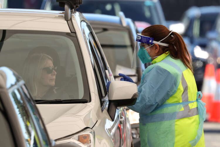 FILE PHOTO: A medical worker prepares to administer a test at the Bondi Beach COVID-19 testing centre in Sydney
