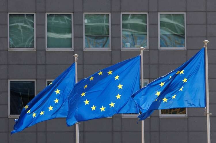 European Union flags wave outside the EU Commission in Brussels amid gas supply concerns - Global Banking & Finance Review