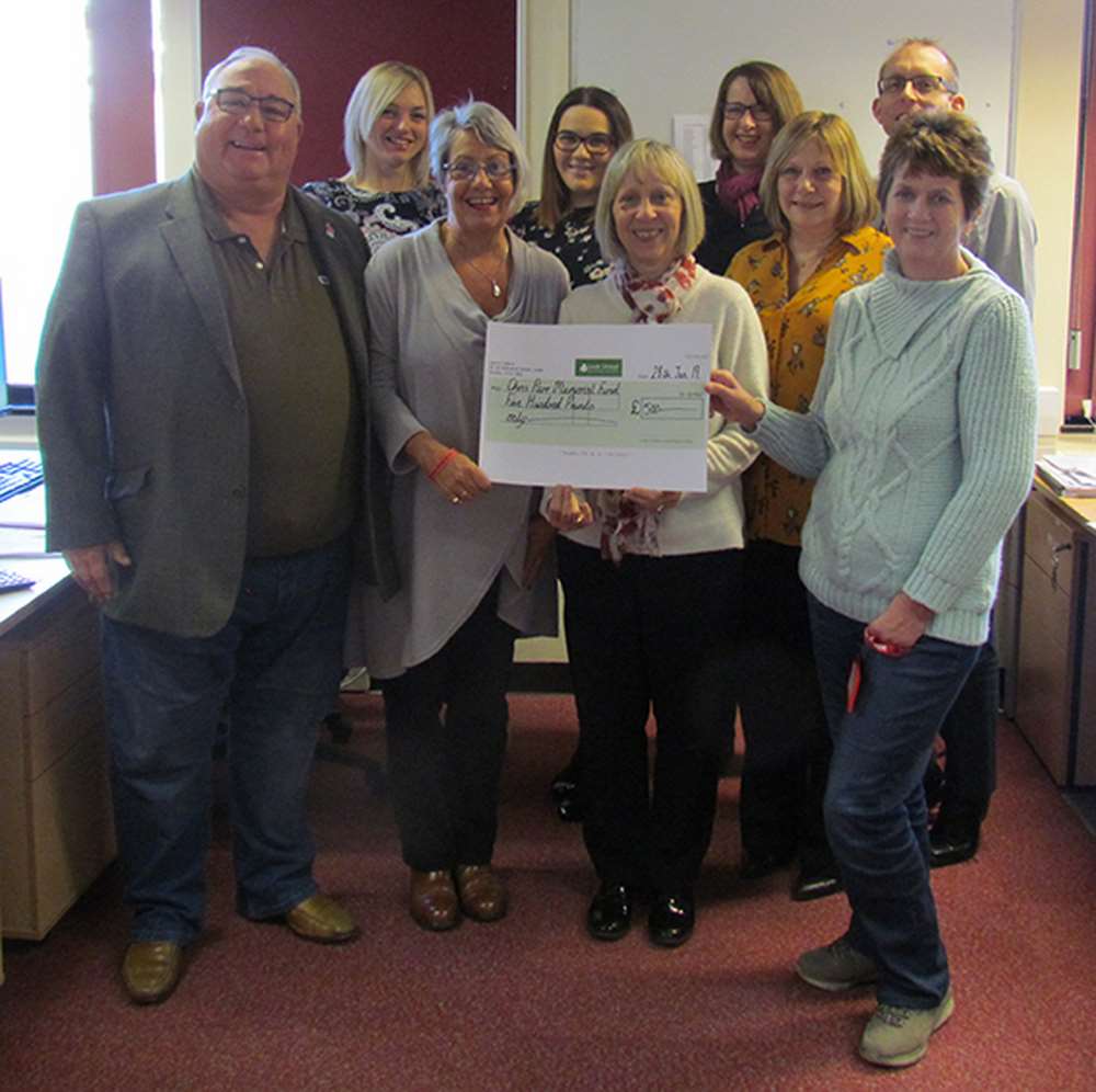 Martin and Dianne Parr (front row, left and second from left) receive the £500 cheque from members of Leek United’s Mortgage Operations team. Martin and Dianne Parr (front row, left and second from left) receive the £500 cheque from members of Leek United’s Mortgage Operations team.