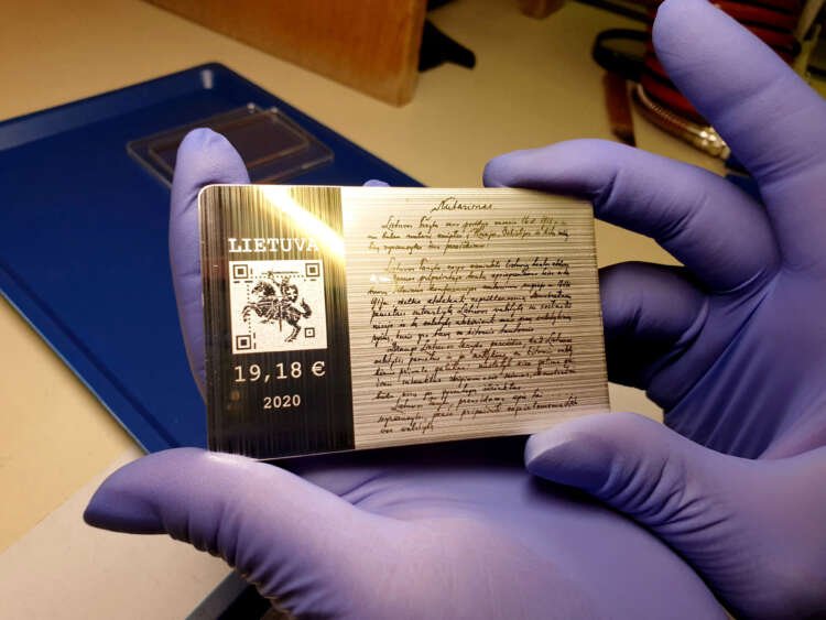 A worker at the Lithuanian mint holds a silver coin symbolizing digital currency - Global Banking & Finance Review