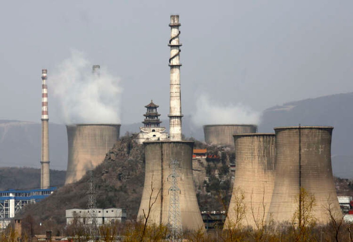 Smoke rises from chimneys at a Beijing steel factory, highlighting carbon emissions in China's industrial sector - Global Banking & Finance Review