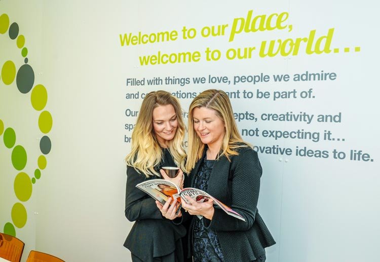 Creative agency WATERS team members at MIT conference discussing staff training investment - Global Banking & Finance Review