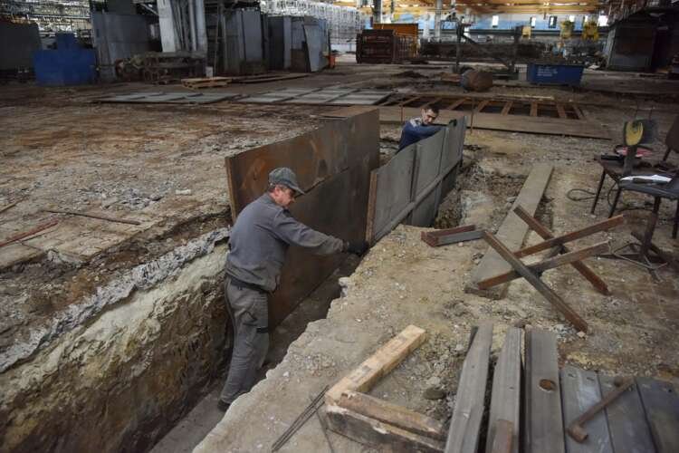 Workers setting up a fire truck production facility relocated due to the Ukraine crisis - Global Banking & Finance Review