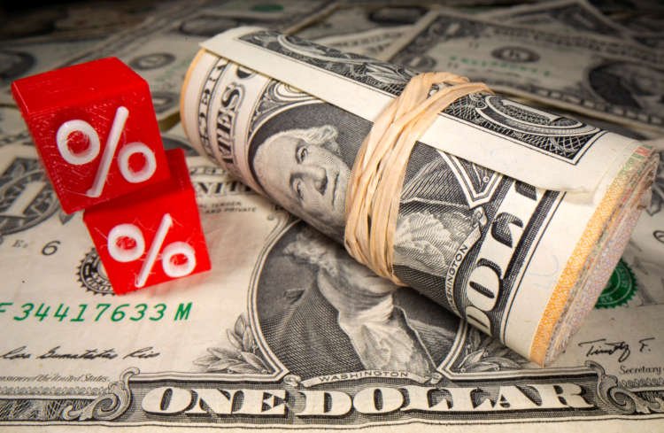 3D printed percentage symbols in front of dollar banknotes related to trading - Global Banking & Finance Review