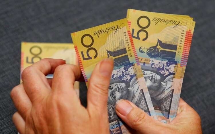 Australian dollars with financial charts symbolizing currency stability - Global Banking & Finance Review