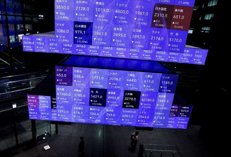 Visitors observe stock prices at a Tokyo conference amid global market shifts - Global Banking & Finance Review
