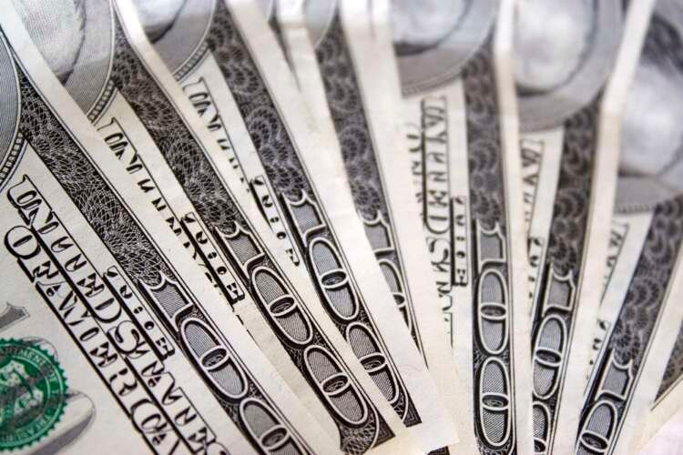 Macro shot of cash fanned out, symbolizing accessible credit in open banking - Global Banking & Finance Review