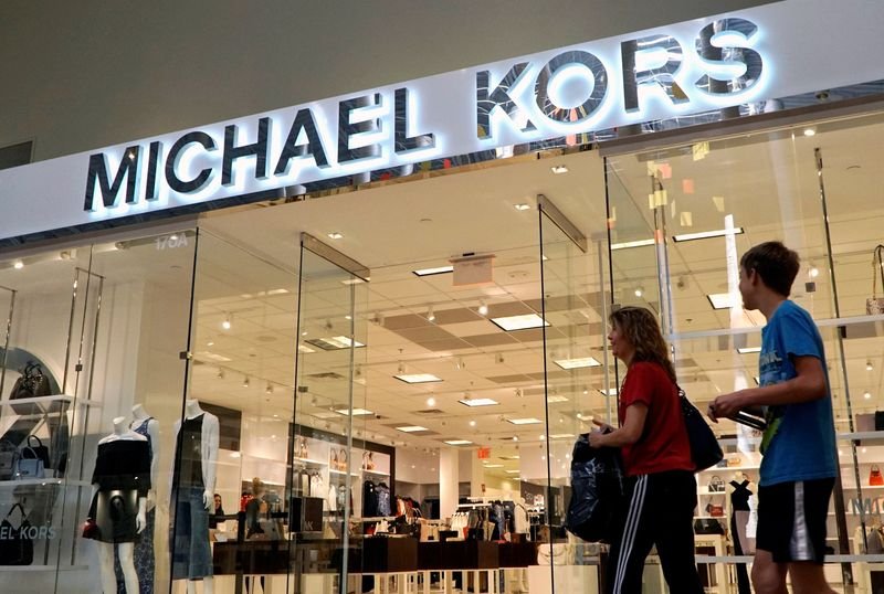 Michael Kors and Capri Holdings logo symbolizing slow luxury demand recovery - Global Banking & Finance Review