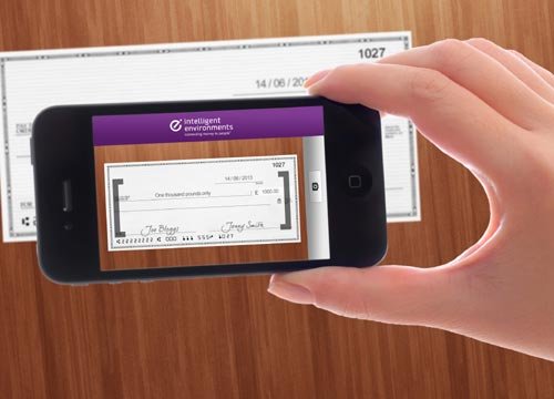 Person using a smartphone to deposit a cheque, illustrating mobile banking trends - Global Banking & Finance Review