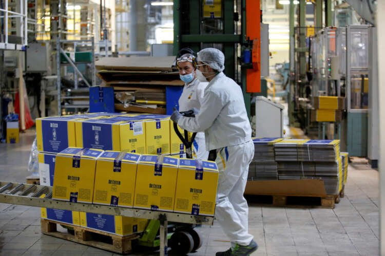 Worker transporting packaged pasta at factory amid euro zone economic contraction - Global Banking & Finance Review