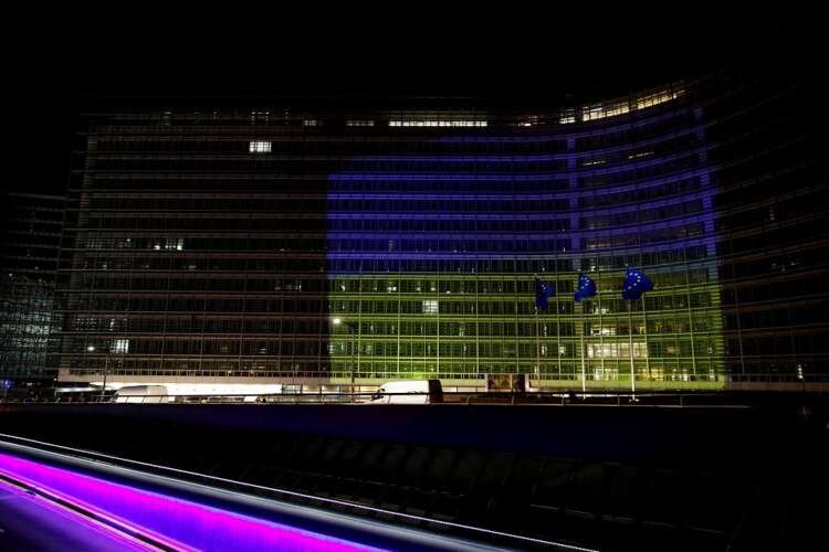 European Commission building illuminated in Ukrainian colors, symbolizing EU support for Ukraine's economy - Global Banking & Finance Review