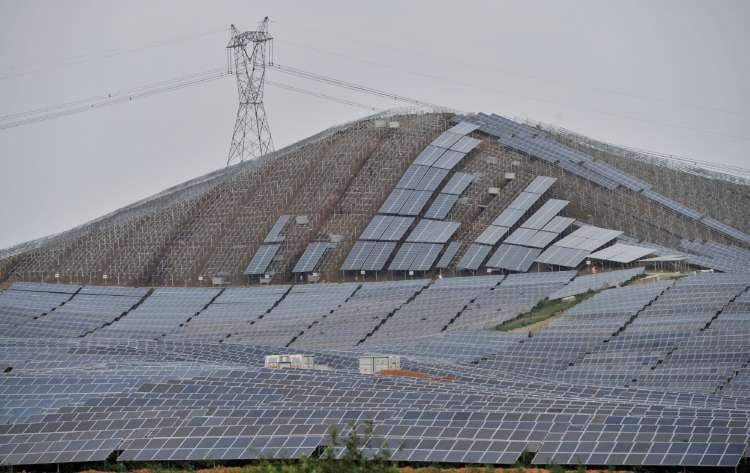 Electricity pylon above a solar power plant in Wuhu, symbolizing China's green bond growth - Global Banking & Finance Review